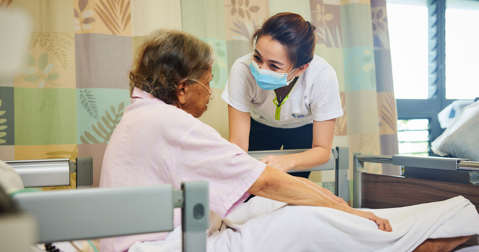 Ms Goh tends to an elderly patient at KTPH.